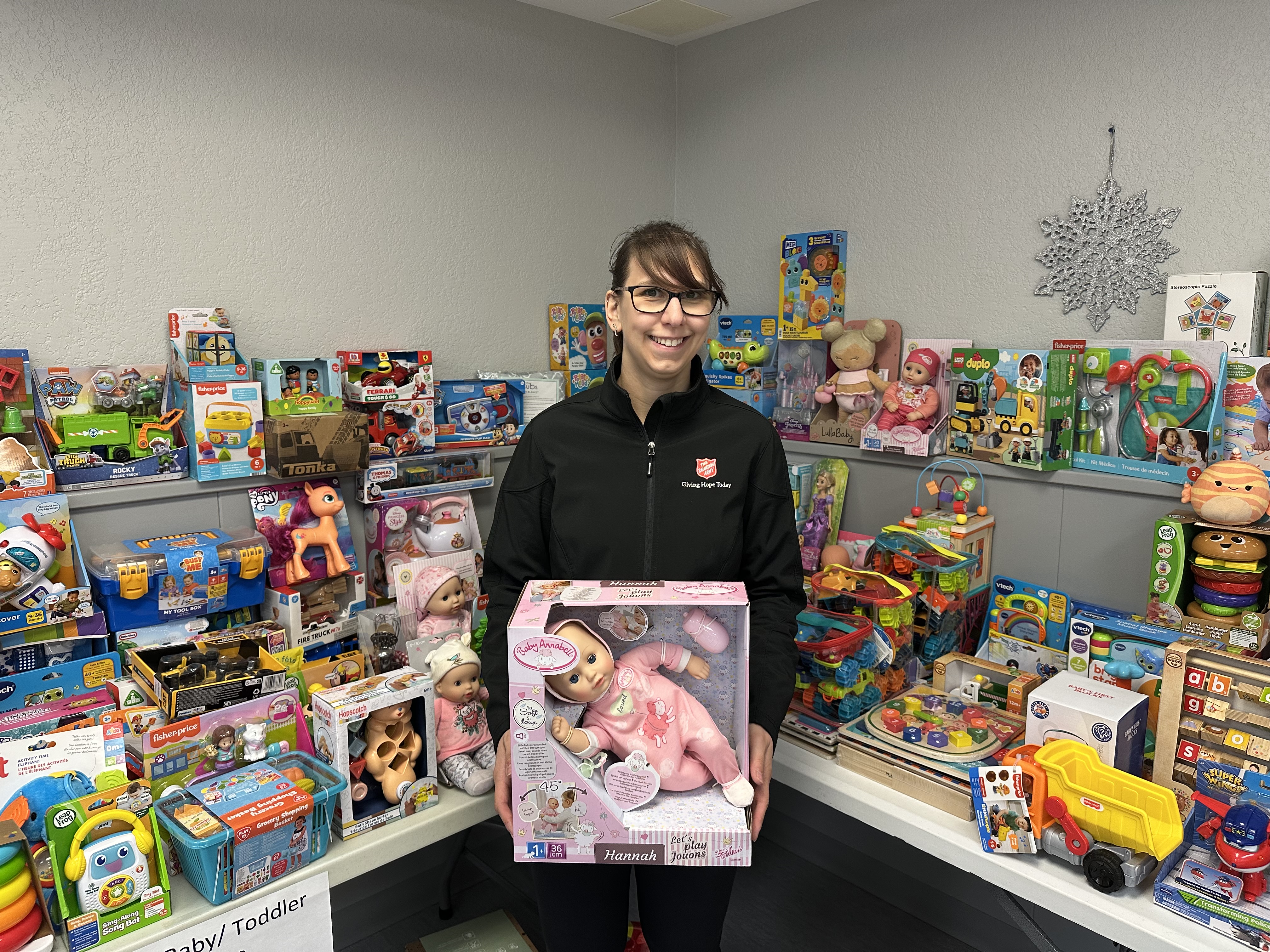 Salvation Army worker stands by toys for distribution