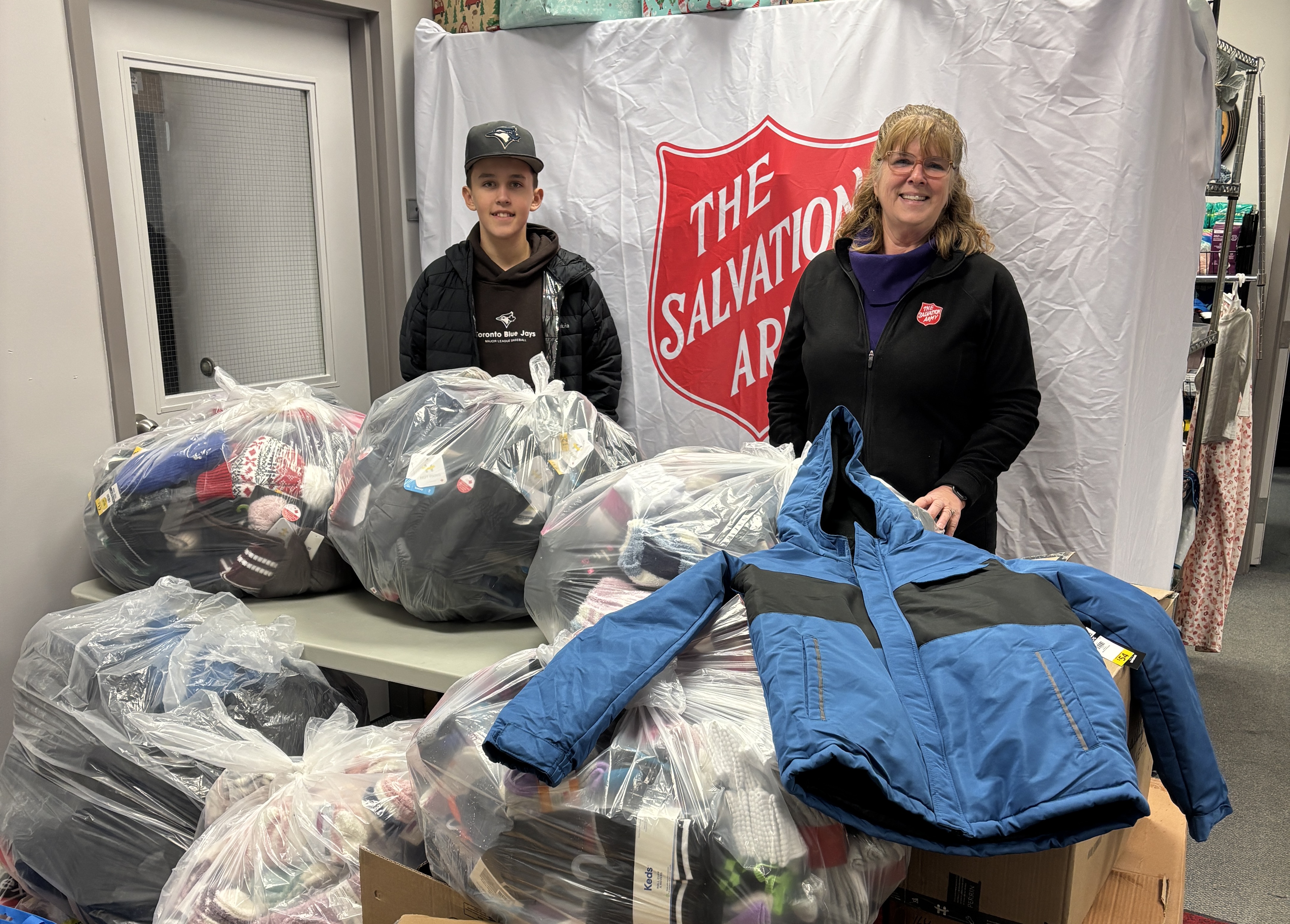 Owen stands with donated winter wear