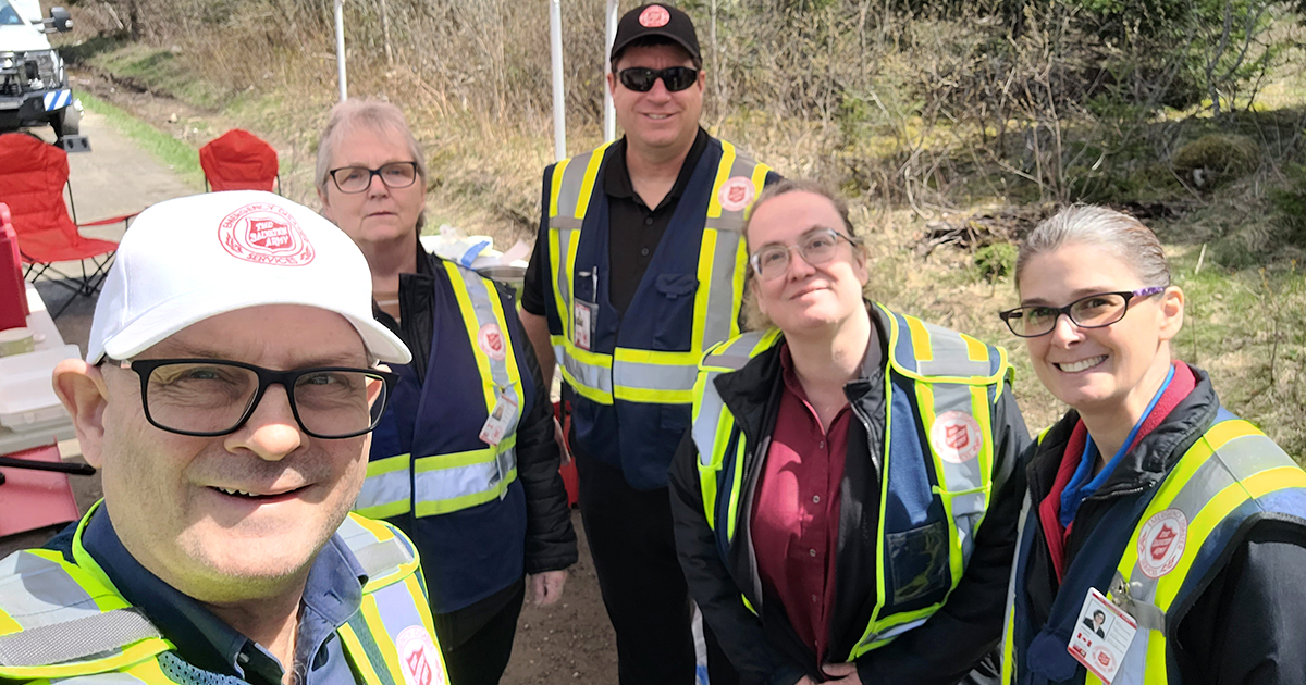 Five people dressed in Salvation Army emergency disaster services gear